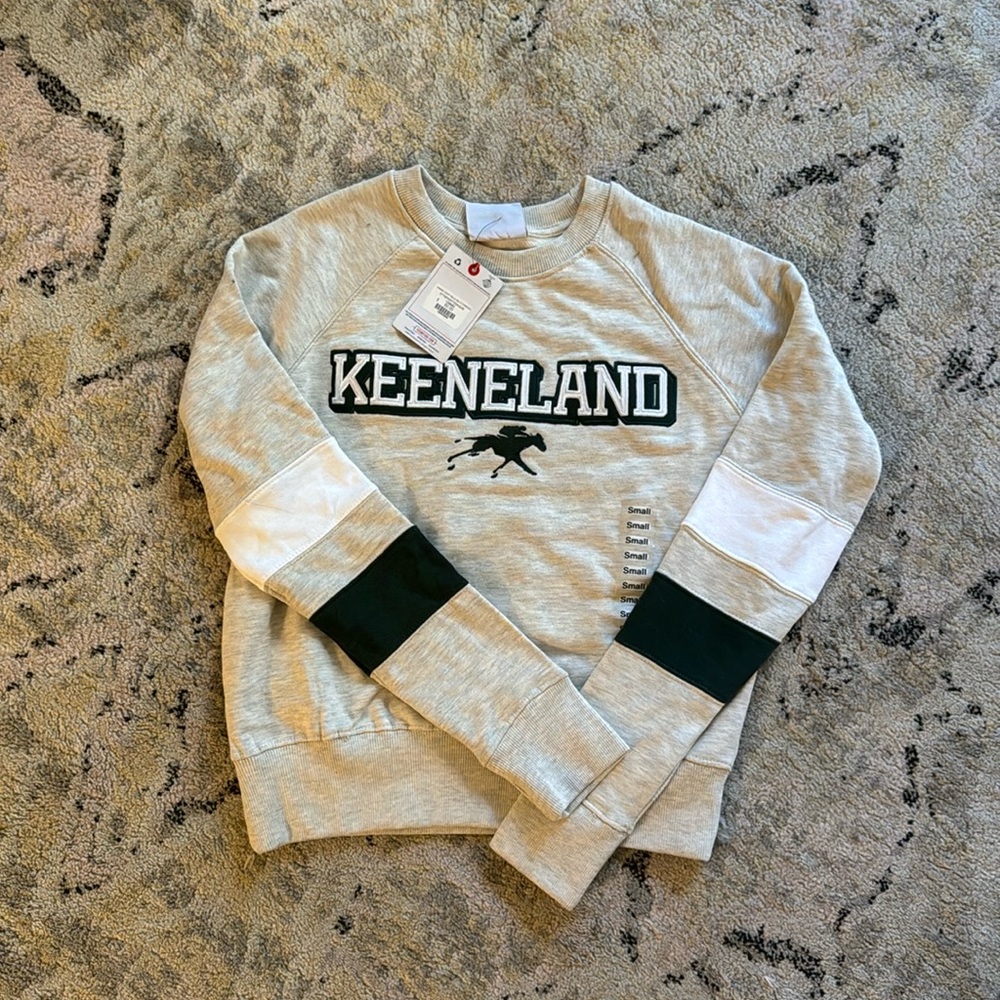 Cream champion Keeneland sweatshirt. Never been worn.